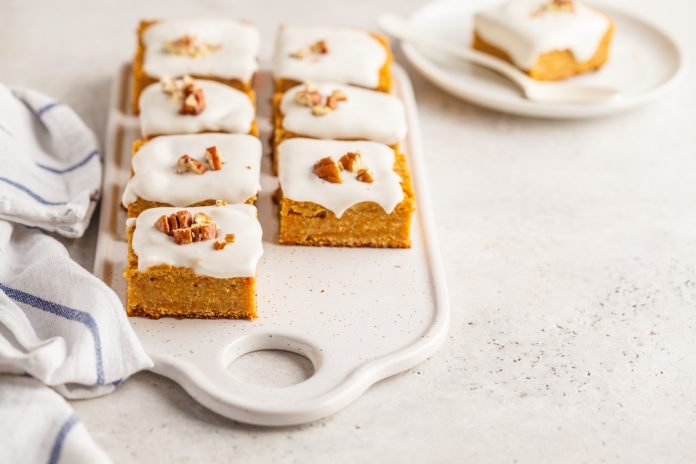 Vegan carrot cake with coconut cream and pecan, plant based diet concept, copy space.
